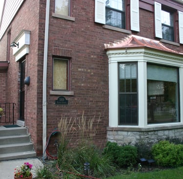Custom made poplar trim and a new copper "roof" on the big bay window. Restoration nearly complete.
