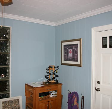 The former 3 season room "den" before renovation. Cheap paneling on walls.