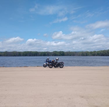 BMW S1000 XR and Triumph Bonneville on the shore of the Mississippi circa 2021