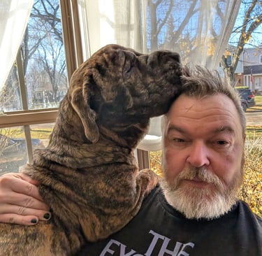 Marty and un-showered me somehow sharing a small chair in the frontroom. Fall 2025