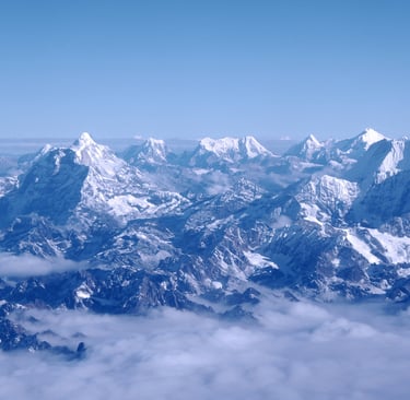 an aerial shot of the Himalayan mountain range on a clear day