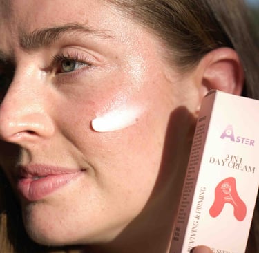 Woman applying Aster 2-in-1 Day Cream on her face, showing healthy glowing skin with pink box.