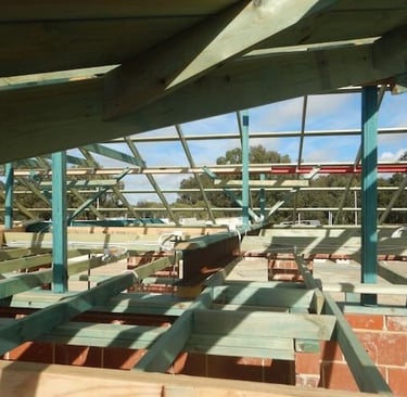 Inspection of a Perth roof frame during a staged building inspection. 