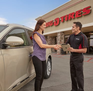 A Big O Tires employee helping a customer