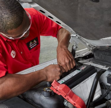 A Big O Tires employee is working on a car