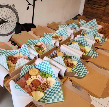 a table with boxes of charcuterie