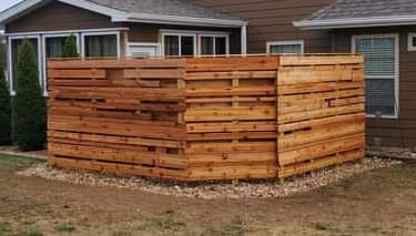a fenced in area with a wooden fence and a house