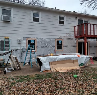 a house with a deck and a deck with a table and chairs
