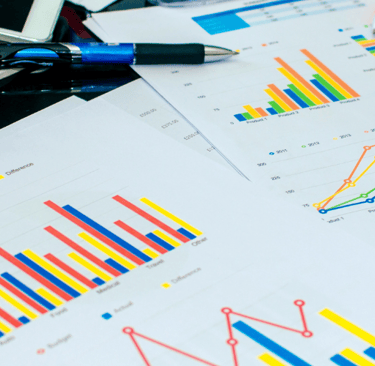 graph reports on desk with calculator