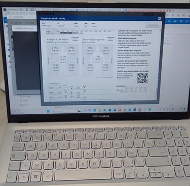 a laptop computer sitting on a table with a keyboard