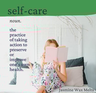 Cayla Henri: a woman sitting on a couch with a book in front of her