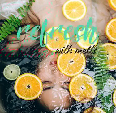 Cayla Henri Wax Melts: a woman in a bathtub with oranges and lemonade