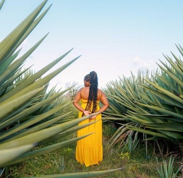a woman in a yellow dress standing in a field