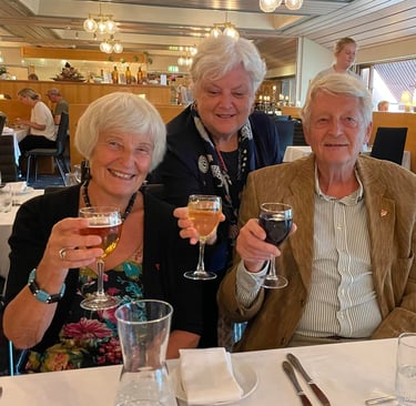 two women and one man toasting
