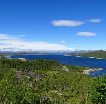 looking down on a lake and some houses with a blue sky
