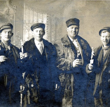 a black and white image of 5 men in fur coats and hats holding bottle so champagne
