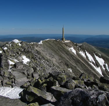 A tall concrete tower stands at the top of a peak-Gausta-istock