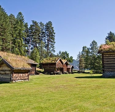 grass roofed wooden buildings in a valley-Kviteseid Bygdemuseum-cite