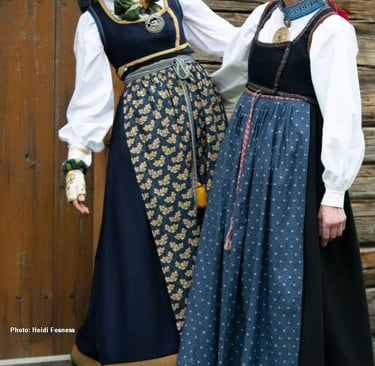 Two women wear bunad with colorful aprons