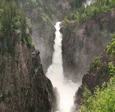 A tall waterfall in a gorge-Rjukan falls-wikimedia-cite