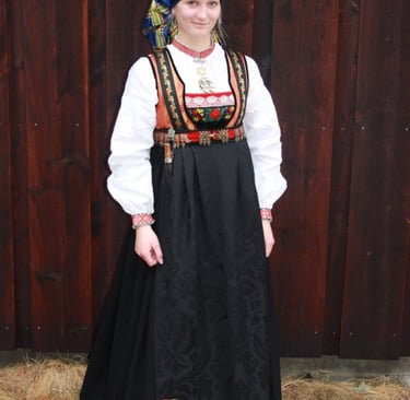 A woman wearing a head scarf and an empire waisted bunad