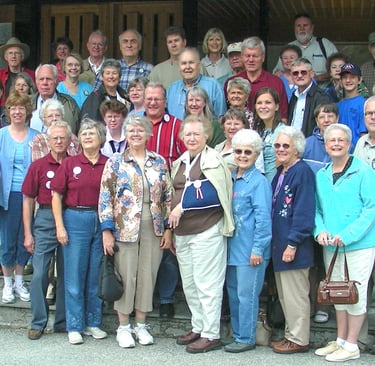 a large group of tour members posing on stairs