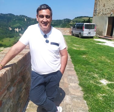 a man in a white shirt and tie dyes a tie