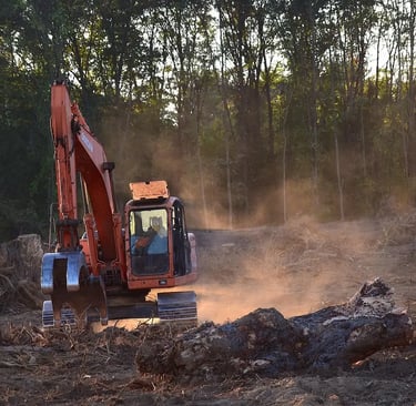 a tractor with a tractor loader in the dirt