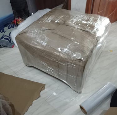 Seemanchal Packers and Movers Katihar using heavy-duty corrugated sheets for safe furniture packing.