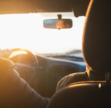 couple driving into sunrise
