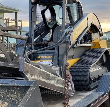 a construction tractor loaded onto a trailer