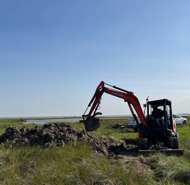 a construction digger working near the coastline
