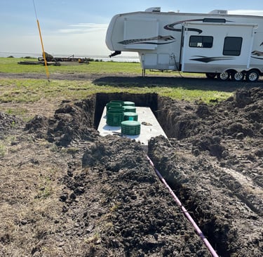 a RV parked beside a newly installed septic system