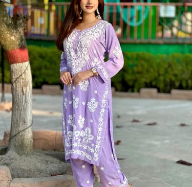 a woman in a purple dress with a white shirt and gold sandals