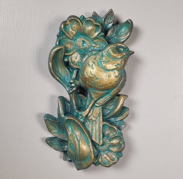 Sculpture of a sparrow perched  on a flower stem. Traditional tattoo inspired art. 