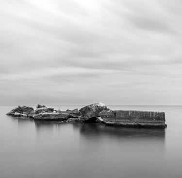 a black and white photo of a rock formation