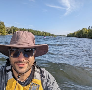 a man in a hat and sunglasses on a boat