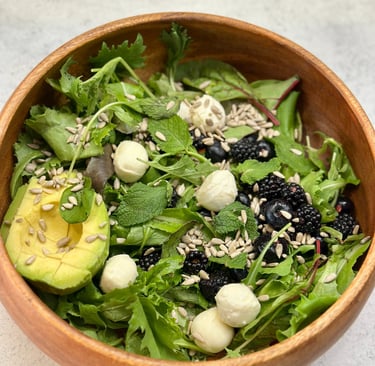 red fruits salad with blueberries, blackberries and avocado