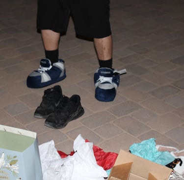 a person standing in front of a box of shoes