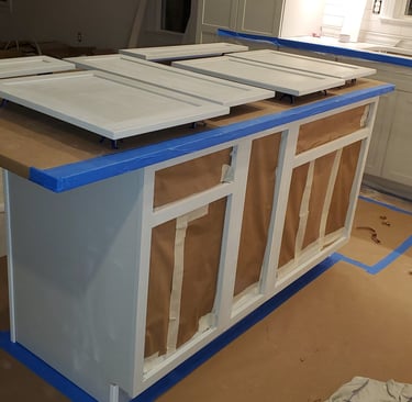 a kitchen island with a counter top and cabinets