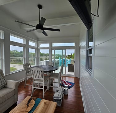 a white painted sun living room with a couch and a table