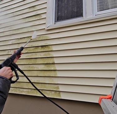 a man is powerwashing the exterior of a home
