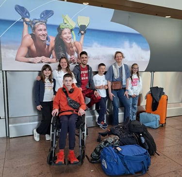 a group of people standing around a group of luggage