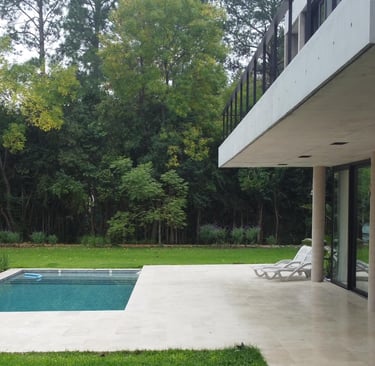 a pool with a chair and a table