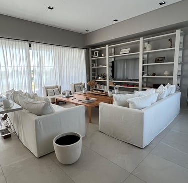 a living room with a large white couch and a coffee table