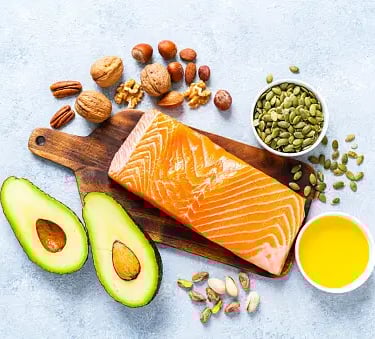 a salmon steak with avocado, nuts, nuts, and nuts