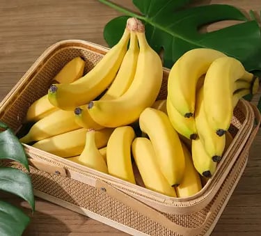 a basket of bananas and a banana peeler