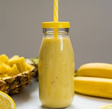 a glass jar of lemonade with a strawberries and lemonade