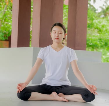 a woman sitting in a yoga pose