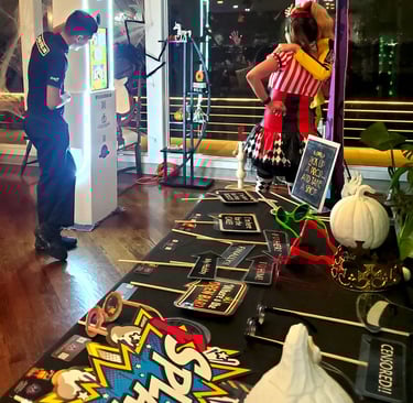 Photo booth staff assisting guests at an LED Mirror Photo Booth with colorful lights during an event